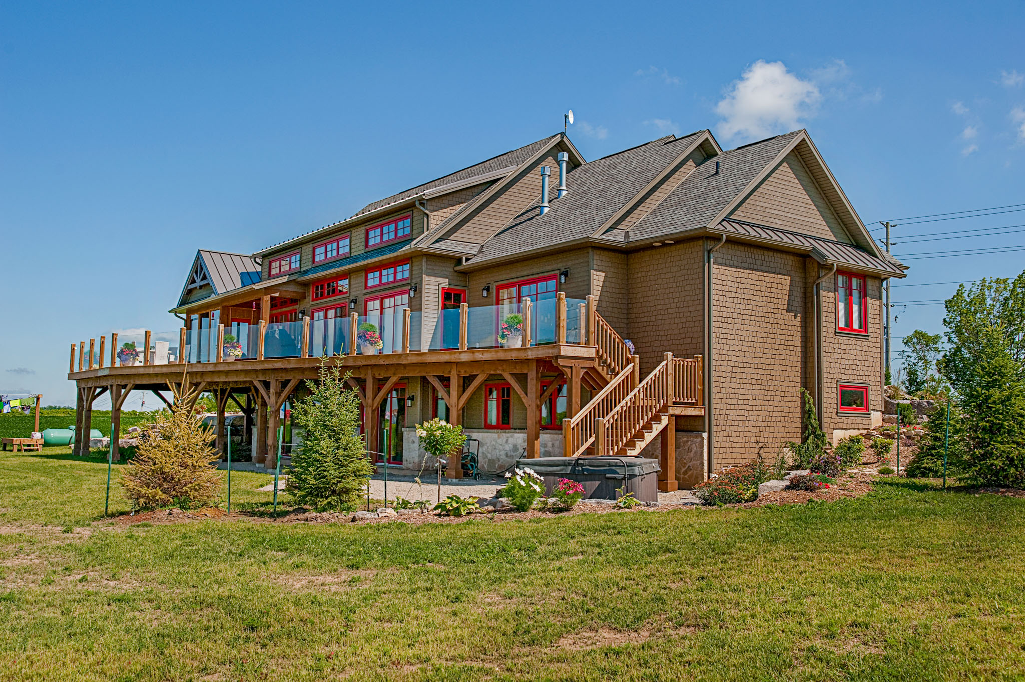 Siderman House with brown maibec wood siding. Staggered shakes and eavestrough