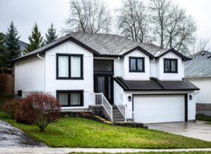 White house with lp smartside board and batten siding with black eavestrough