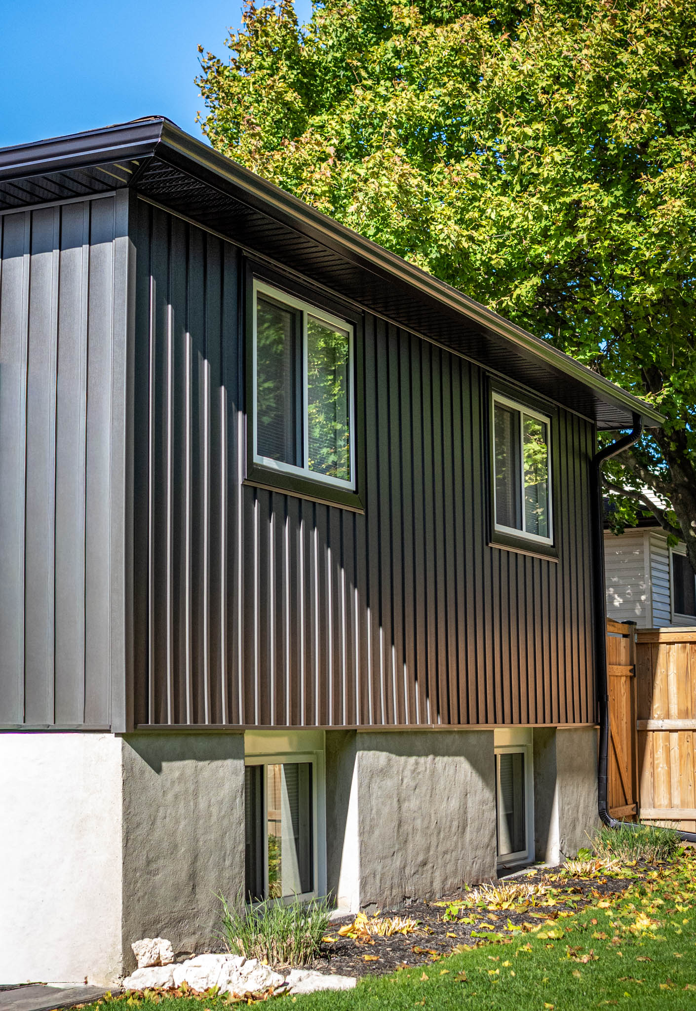 Black seamless eavestrough on house